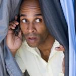 man in closet on phone