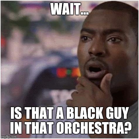 Watching pre-1990s orchestra concerts on YouTube, and suddenly... |  WAIT... IS THAT A BLACK GUY IN THAT ORCHESTRA? | image tagged in shocked black guy,memes,music,orchestra,thatbritishviolaguy,peter whitehead | made w/ Imgflip meme maker
