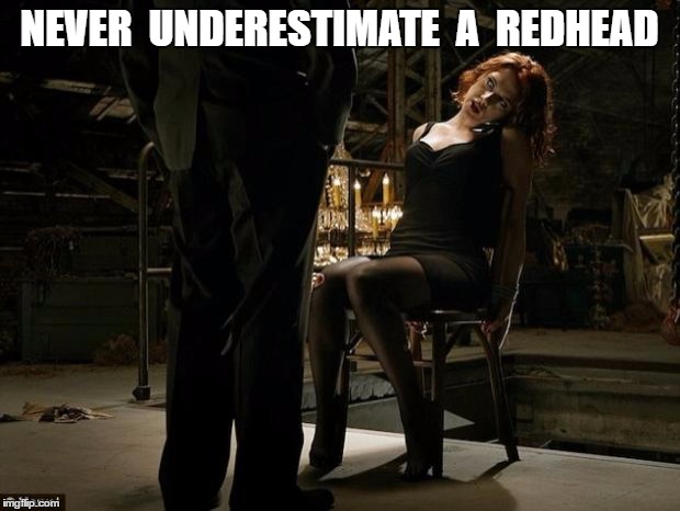 Avengers Black Widow tied to a chair | NEVER  UNDERESTIMATE  A  REDHEAD | image tagged in avengers black widow tied to a chair | made w/ Imgflip meme maker