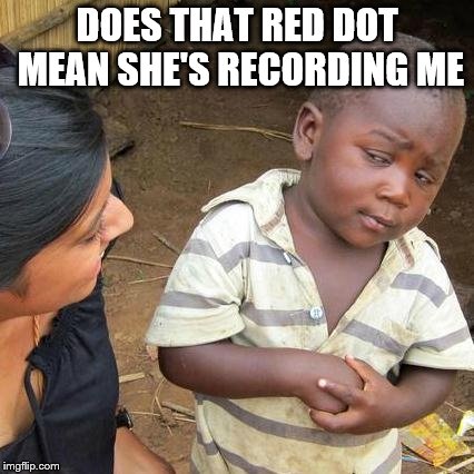What is it? | DOES THAT RED DOT MEAN SHE'S RECORDING ME | image tagged in memes,confused,funny,skeptical,black,kid | made w/ Imgflip meme maker