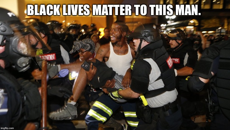 The firefighter in the picture is carrying one of the protesters from Charlotte who was shot by a rioter.  | BLACK LIVES MATTER TO THIS MAN. | image tagged in firefighter in charlotte,black lives matter,charlotte,riots | made w/ Imgflip meme maker