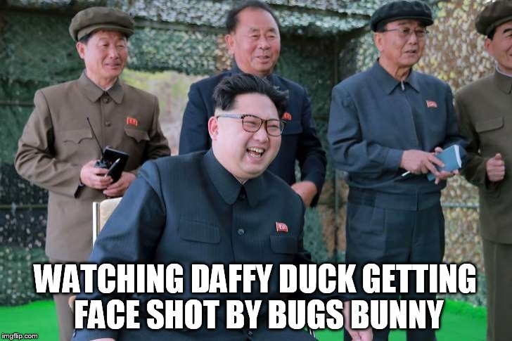 kim jong il | WATCHING DAFFY DUCK GETTING FACE SHOT BY BUGS BUNNY | image tagged in kim jong il,daffy duck,military humor,north korea | made w/ Imgflip meme maker