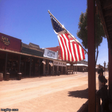 Stagecoach in Tombstone. | image tagged in gifs,tombstone,arizona,stagecoach,americanflag,western | made w/ Imgflip images-to-gif maker