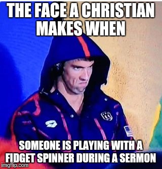 Triggered Christian  | THE FACE A CHRISTIAN MAKES WHEN; SOMEONE IS PLAYING WITH A FIDGET SPINNER DURING A SERMON | image tagged in memes,michael phelps death stare,funny,fidget spinner,meme,christian | made w/ Imgflip meme maker