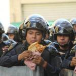 Mexican police on lunch eating Quesadillas