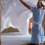 Maid making bed