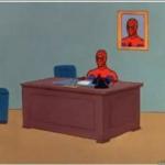 Spider man behind desk