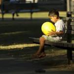 sad child playing alone