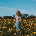 young woman in field of flowers meme