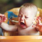 Baby crying over pureed veggies