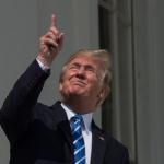 Donald Trump looking at eclipse