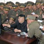 Kim Jong Un pointing at screen