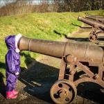 girl looking in cannon