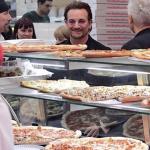 Bono looking at pizza