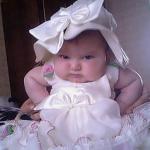 angry baby in white dress