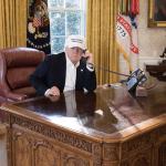 Trump sitting at empty desk
