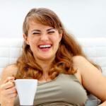 Woman with coffee laughing