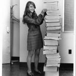 woman with a stack of paper