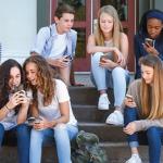 teens staring at phones 476x400