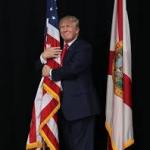 Trump grouping the flag.