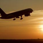 Airplane taking off sunset