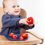 Cranky baby with tomato