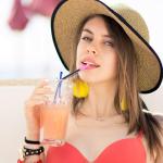 Beautiful woman in hat with beverage