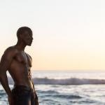 Black man on beach shirtless