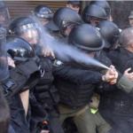 police officer pepper spraying himself
