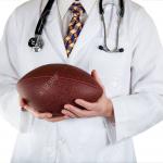 Doctor holding football