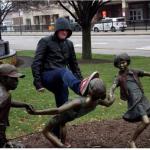 Man kicking statue