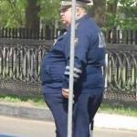 Fat cop behind pole