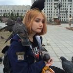 Girl with pigeons on her