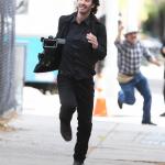 Keanu Reeves running from paparazzi