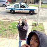 Kid flipping off cops