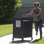 Librarian Running with Book Cart