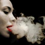 Woman Blows Smoke