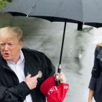 Trump dry under umbrella Melania soaking wet in the rain