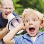 man yelling at a child using a bullhorn