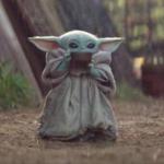 Baby Yoda drinking from cup