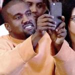Kanye taking photos or taking pictures