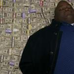 guy sleeping on pile of money