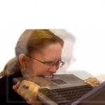 Woman biting laptop