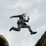 Man Jumping Across Chasm