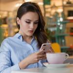 Woman on phone but not looking happy