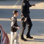 Policeman talking to kid on a scooter