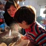 child spitting on a birthday cake