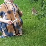 Grandma holding knife behind back while coaxing rabbit closer