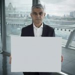 Sadiq Kahn holding a sign