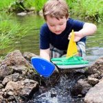 Kid playing with boat